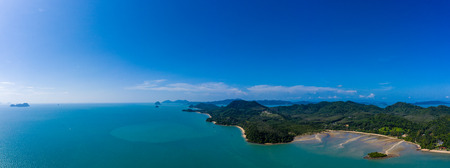 Aerial panoramic view of a beautiful green tropical island with bays and sandy beachesの写真素材