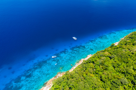 Aerial drone view of diving and snorkel boats around the beautiful tropical Similan Islands in Thailandの写真素材