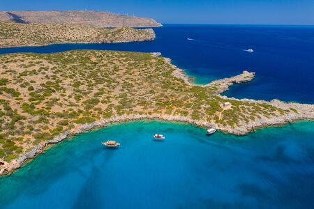 Aerial drone view of boats and swimmers in a crystal clear, blue, warm oceanの写真素材