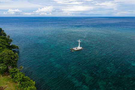 Aerial view of the sunken cemetery off the coast of the green volcanic island of Camiguinの写真素材