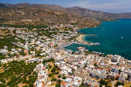 ELOUNDA, CRETE, GREECE - JULY 16 2019: Aerial view of the popular high-end tourist town of Elounda on the Greek island of Crete in the Aegean Sea.のeditorial素材