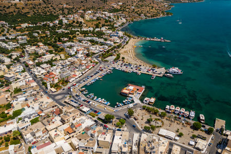 ELOUNDA, CRETE, GREECE - JULY 16 2019: Aerial view of the popular high-end tourist town of Elounda on the Greek island of Crete in the Aegean Sea.のeditorial素材