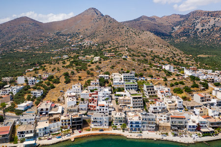 ELOUNDA, CRETE, GREECE - JULY 16 2019: Aerial view of the popular high-end tourist town of Elounda on the Greek island of Crete in the Aegean Sea.のeditorial素材