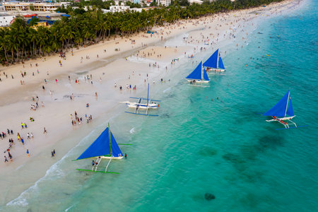 BORACAY, PHILIPPINES - 18 JUNE 2019: Crowds gathering on Boracay Island's White Beach to watch the sunset.  Boracay Island was closed and recently reopened to tourists by the Philippine Government.のeditorial素材