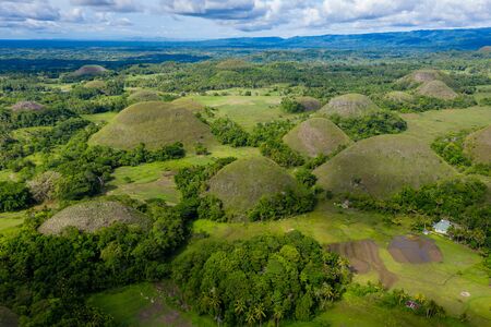 Aerial drone view of the unique scenery of the Chocolate Hills landscape in Bohol, Philippinesの写真素材