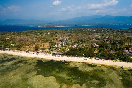 Aerial drone view of a beautiful tropical beach and coral reef on a small island (Gili Air, Indonesia)の写真素材