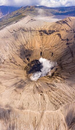 Aerial view of the crater of an active volcano emitting gas and fumes (Mount Bromo, Java)の写真素材