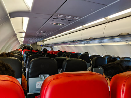 BANGKOK, THAILAND - JUNE 05 2020: Passengers on board a domestic Air Asia flight to Bangkok following the resumption of domestic flights during the coronavirus pandemic. Airlines have introduced social distancing measures such as mandatory facemasks, no mのeditorial素材