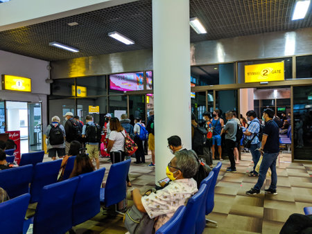 SURAT THANI, THAILAND - JUNE 05 2020: Passengers queue for temperature checks before boarding a domestic flight to Bangkok.  Thailand has begun to resume domestic flights following the worldwide Coronavirus pandemic.のeditorial素材