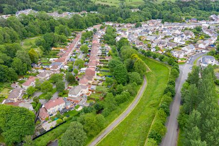 Aerial drone view of a residential area of a small Welsh town surrounded by hills (Ebbw Vale, South Wales, UK)の写真素材