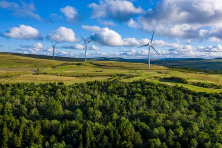 Aerial drone shot of several clean energy wind turbines in a rural area of South Wales, UKの写真素材