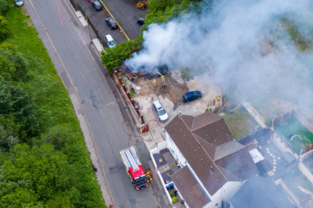 EBBW VALE, WALES, UK - JUNE 26 2020: Aerial view of firefighters tackling a small blaze in a domestic outbuilding. The fire was extinguished within minutes.のeditorial素材