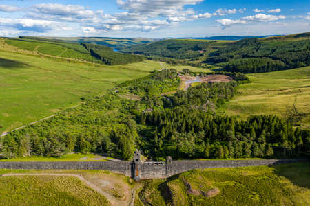 Aerial view of an empty reservoir with old dam wall (Upper Neuadd Reservoir, Brecon Beacons, Wales)