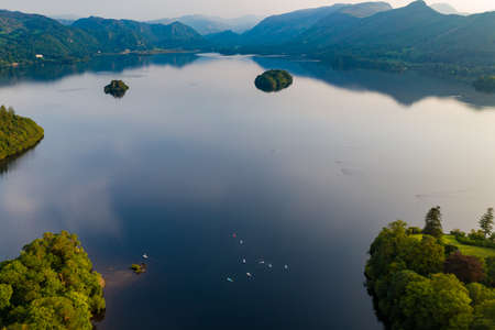 Aerial view of a large, beautiful lake with islands at sunset (Derwent Water, Lake District, England)の写真素材