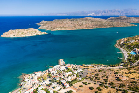 Aerial view of the medieval fortress of Spinalonga island and town of Plaka with crystal clear seas (Crete, Greece)のeditorial素材