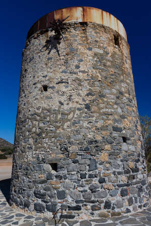Remains of old, stone windmills on the Kolokitha peninsula near the town of Elounda, Creteの写真素材