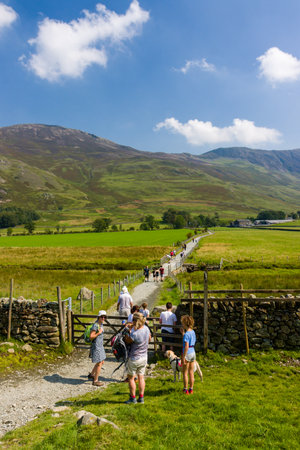 BUTTERMERE, ENGLAND - AUGUST 12 2020: Groups of walkers around Buttermere in England's Lake District National Parkのeditorial素材