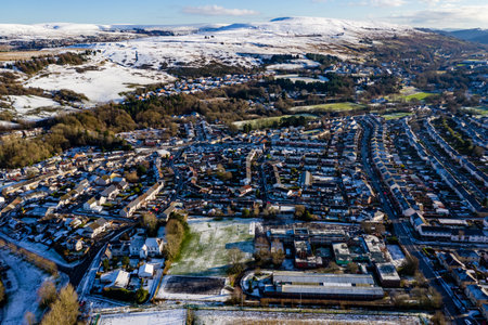 Aerial view of a snow covered town on a bright, sunny winters day (Wales, UK)の写真素材