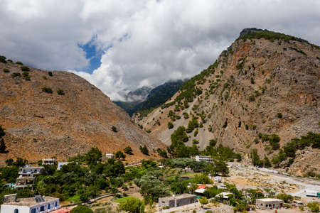 Aerial view of towering, cloud covered mountains at the exit of the Samaria Gorge (Agia Roumeli, Crete)の写真素材
