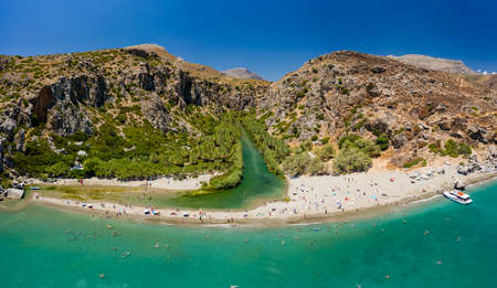 Aerial view of a beautiful sandy beach and palm tree lined gorge (Preveli, Crete, Greek)の写真素材