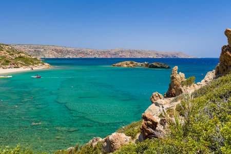 VAI, CRETE - 15 JULY 2021: Crowds of tourists on the picturesque palm fringed beach of Vai on the eastern coast of Crete (Greece)のeditorial素材