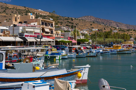 ELOUNDA, CRETE - 11 JULY 2021: Colorful traditional fishing boats and equipment at the port in the town of Elounda in Lasithi, Crete (Greece)のeditorial素材