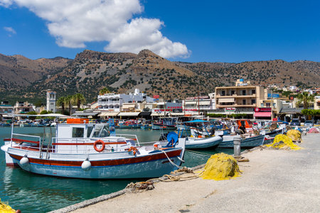 ELOUNDA, CRETE - 11 JULY 2021: Colorful traditional fishing boats and equipment at the port in the town of Elounda in Lasithi, Crete (Greece)のeditorial素材