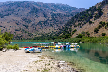 KOURNAS, CRETE - 17 JULY 2021: Pedalo and small boats at Lake Kournas - the biggest freshwater lake on the island of Creteのeditorial素材