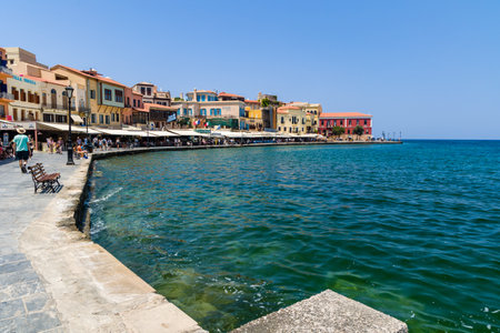CHANIA, CRETE - JULY 17 2021: Crowds of tourists in the ancient Venetian harbour in Chania on the Greek island of Crete.のeditorial素材