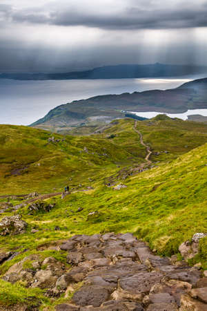 Dramatic stormy skies, sunbeams and mountain scenery at Storr, Isle of Skye, Scotland