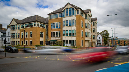 CARDIFF, WALES - SEPTEMBER 16 2021: Long exposure image of traffic at a busy road junction in...
