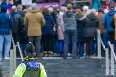 CARDIFF, WALES - NOVEMBER 09 2021: South Wales Police officers and PCSOs observe a demonstration against the increased use of vaccine passports on the steps of the Welsh Parliament in Cardiffのeditorial素材