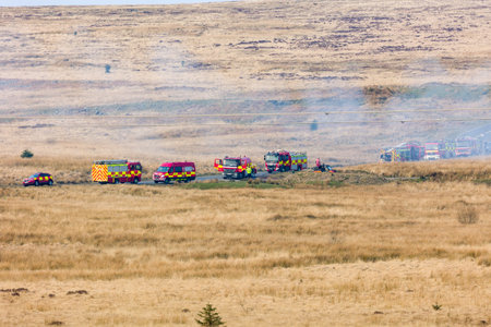 EBBW VALE, WALES - MARCH 24 2022: Fire engines and firefighters attending a large moorland grassfire...