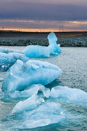 Spectacular glacial lagoon with huge floating icebergs with a winter sunset sky (Jokusarlon lagoon,...