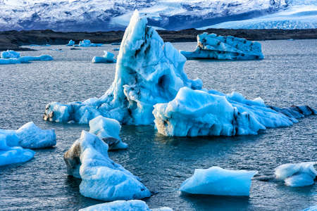 Icebergs in a spectacular glacial lagoon with a sunset sky (Jokusarlon, Iceland)の写真素材
