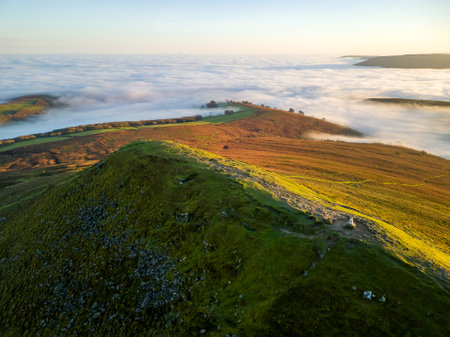 Aerial view of hills rising above a sea of cloud during a temperature inversion (Brecon Beacons, Wales)の写真素材