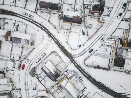 Aerial view of snow covered streets and roads during a blizzard (Wales)