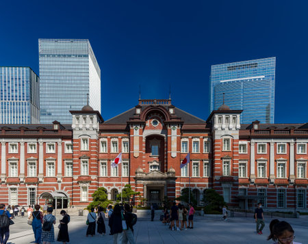 TOKYO, JAPAN - JULY 16 2023: Small crowds of people around the red brick building of Tokyo Central Station on a hot summers dayのeditorial素材