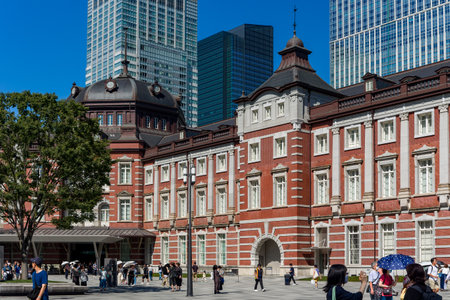 TOKYO, JAPAN - JULY 16 2023: Small crowds of people around the red brick building of Tokyo Central Station on a hot summers dayのeditorial素材