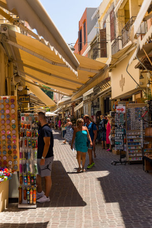 CRETE, GREECE - JULY 03 2023: Crowds of tourists in the old, narrow streets of Chania in western Crete, Greece.のeditorial素材