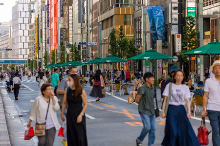 TOKYO, JAPAN - JULY 30 2023: Crowds of shoppers in the high-end luxury retail area of Ginza, central...