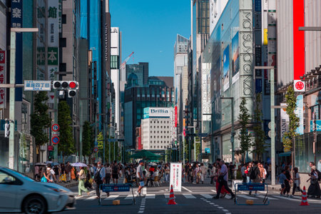 TOKYO, JAPAN - JULY 30 2023: The high-end and luxury shopping district of Ginza, Tokyo on a hot, Sunday afternoon.のeditorial素材