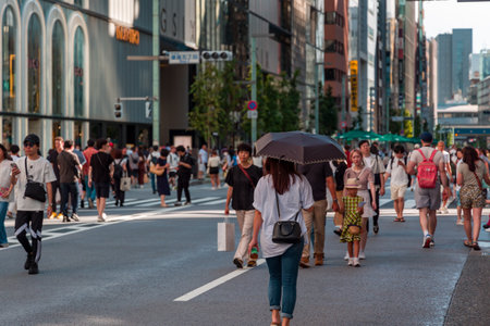 TOKYO, JAPAN - JULY 30 2023: The high-end and luxury shopping district of Ginza, Tokyo on a hot,...
