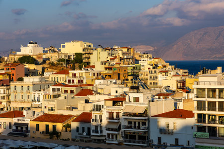 CRETE, GREECE - JULY 10 2023: The lake and harbour area of the town of Agios Nikolaos at sunset (Lasithi, Crete, Greece)のeditorial素材