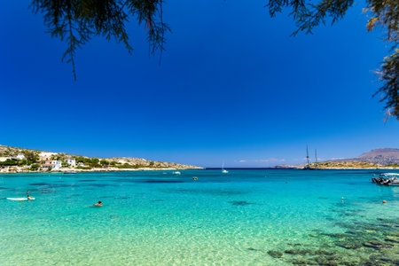 Swimmers in shallow, warm crystal clear ocean waters (Greece)の写真素材