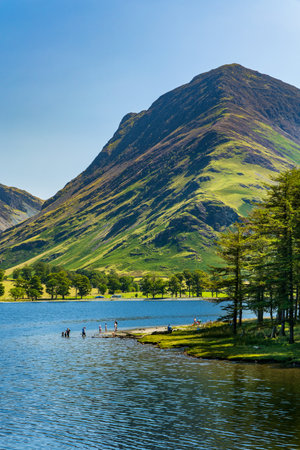 Bathers enjoying hot sumer weather at Buttermere in the English Lake Districtの写真素材