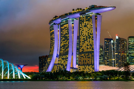 SINGAPORE - NOVEMBER 22 2023: The iconic Marina Bay Sands and other waterfront buildings in downtown Singapore during a stormy sunsetのeditorial素材