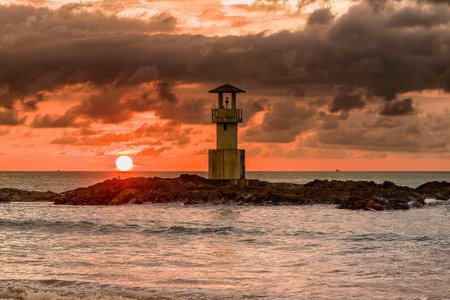 Stormy tropical sunset behind a small lighthouse (Khao Lak, Thailand)の写真素材