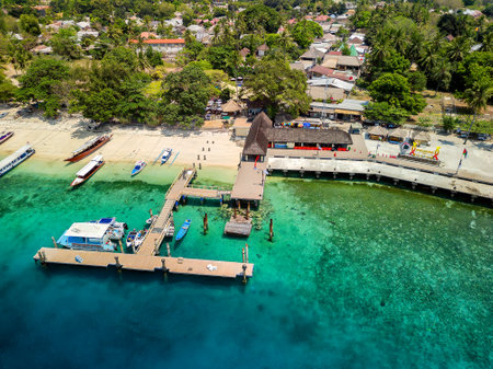 Tourist boats and ferries at the port on the small tropical island of Gili Air in Lombok, Indonesiaの写真素材