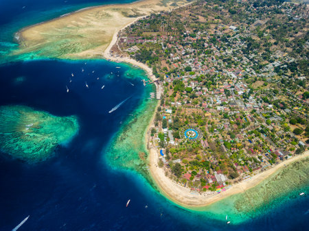 Aerial view of fringing coral reef surrounding a small tropical island in a warm ocean (Gili Air, Indonesia)の写真素材